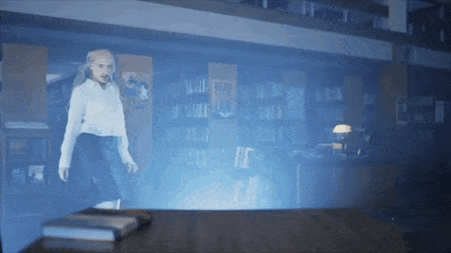 a woman in a white shirt is standing in a library with a blue light behind her