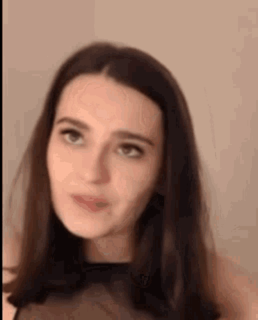 a close up of a woman 's face with a serious look on her face