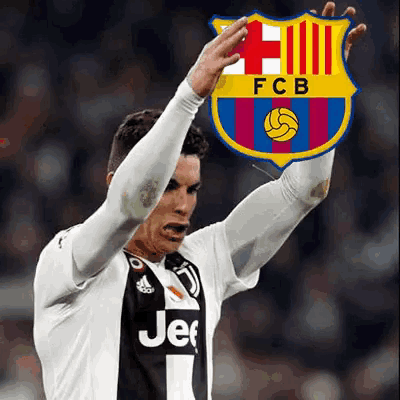 a soccer player in a jeep jersey is holding up a fcb logo