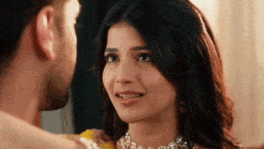 a man and a woman are looking at each other .