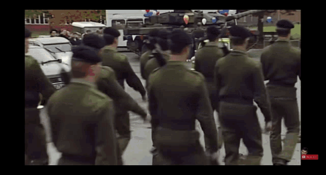 a group of soldiers are marching down the street