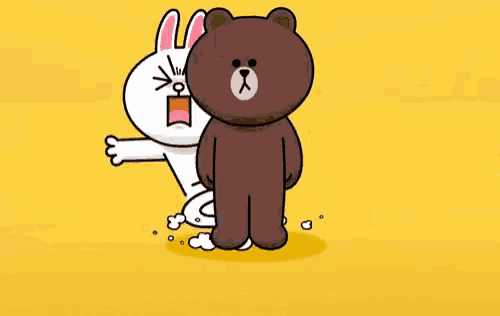 a brown bear and a white rabbit are standing next to each other .