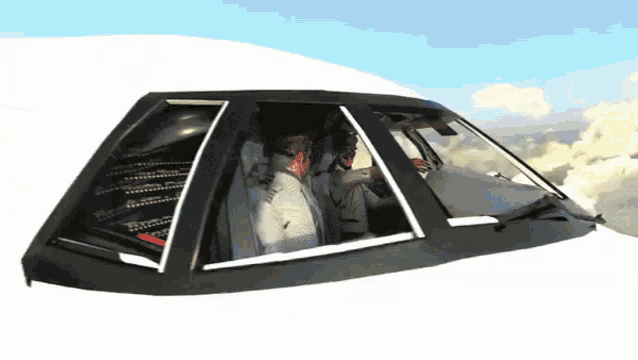 a man is sitting in the cockpit of an airplane looking out the window