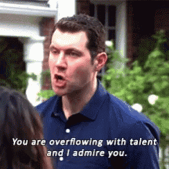 a man in a blue shirt is talking to a woman and says you are overflowing with talent and i admire you