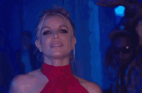 a woman in a red dress with her tongue out