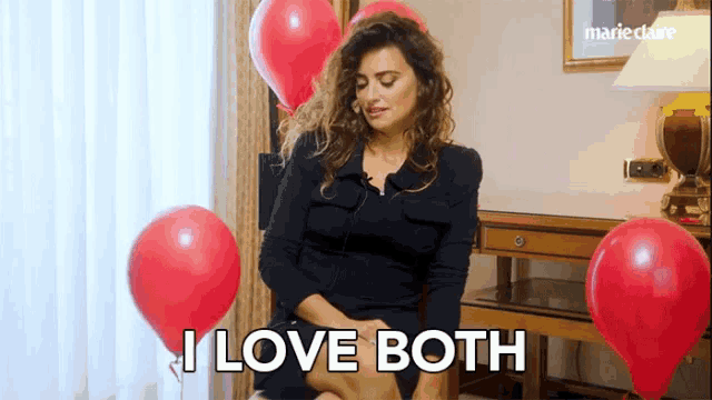 a woman is sitting in front of red balloons and says i love both