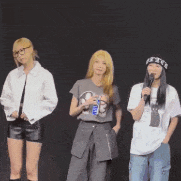 three women standing next to each other with one wearing a t-shirt that says bitch on it