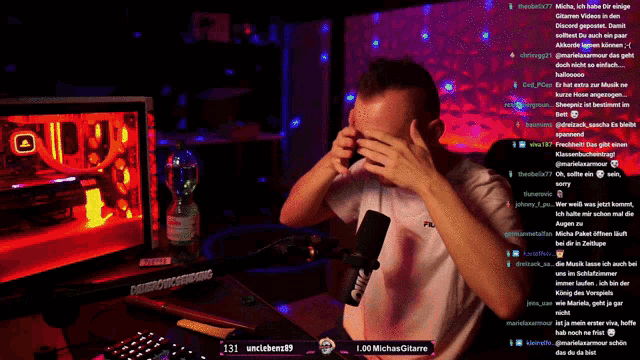 a man holds his head in front of a microphone with the number 131 on the bottom right