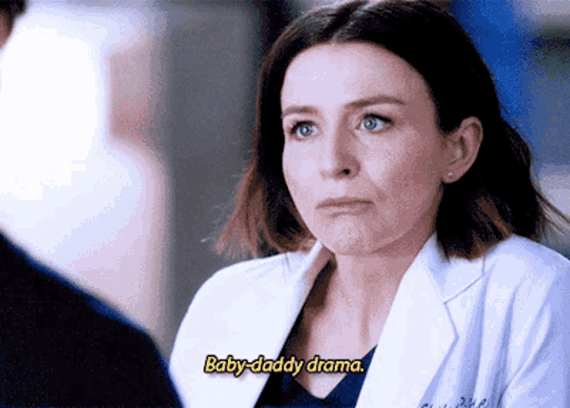 a woman in a lab coat is talking to a man and says baby-daddy drama