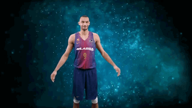 a basketball player with the number 9 on his jersey stands with his arms outstretched