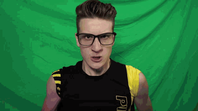 a man wearing glasses and a black shirt that says piiii