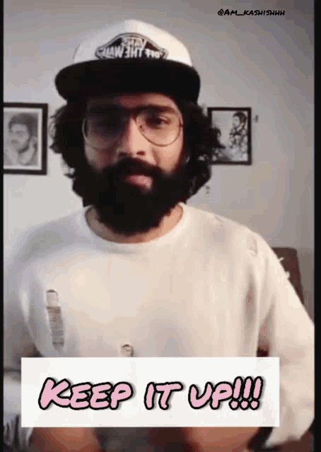 a man with a beard wearing glasses and a hat that says vans on it