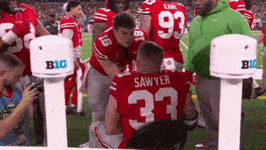 a football player with the number 33 on his jersey is kneeling down