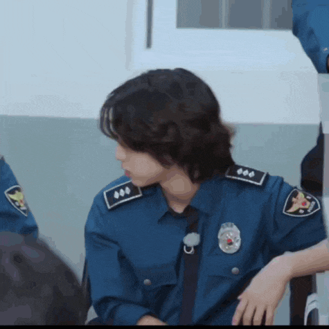 a police officer wearing a blue uniform with a badge on his shoulder
