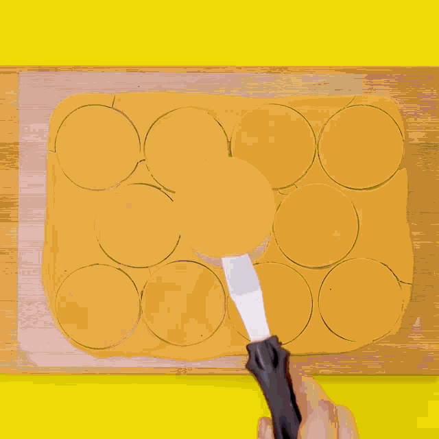 a chocolate cake is sitting on a white plate with a yellow background