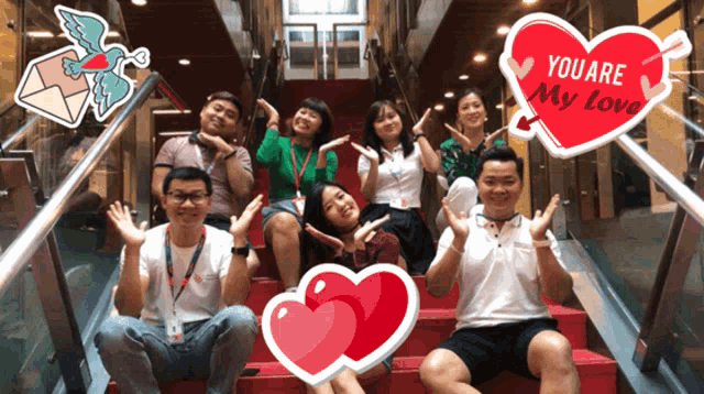 a group of people posing for a photo with a heart that says you are my love