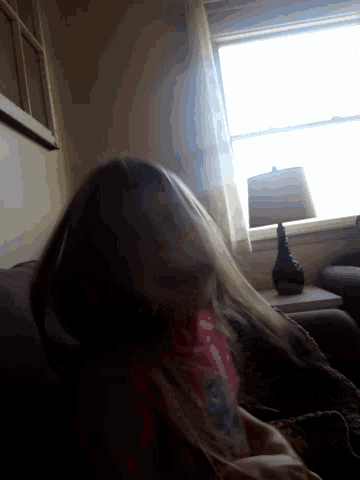 a person laying on a couch with their head on the floor