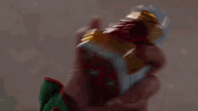 a close up of a person holding a toy