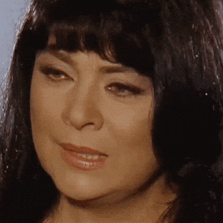 a close up of a woman 's face with a fringe