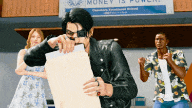 a man is holding a piece of paper in front of a banner that says money is power