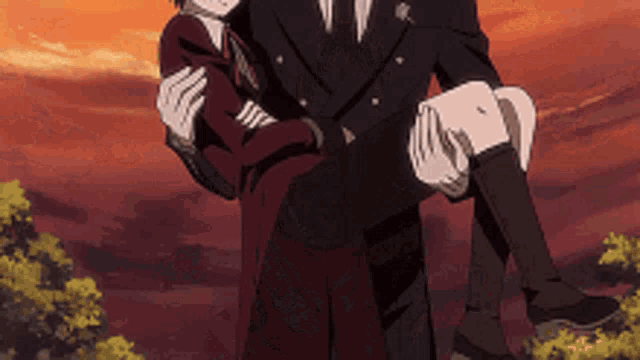 a man is carrying a woman in his arms