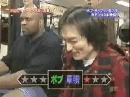 a man and a woman are sitting next to each other with a sign that says bob on it