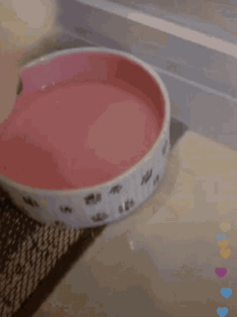 a bowl of food is being poured into a white bowl