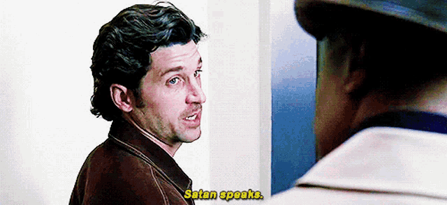 a man talking to another man with the words satan speaks