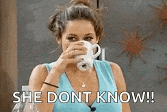 a woman is drinking a cup of coffee and saying she does n't know !