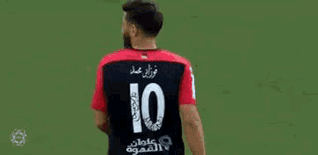 the back of a soccer player wearing a red and black jersey with the number 10 on it .