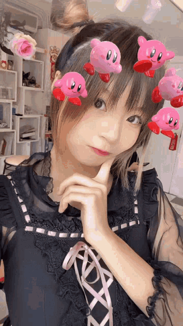 a girl wearing a headband with kirbys on it