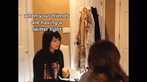 two women talking in front of a mirror with the caption " when your friends are having a twitter fight " above them