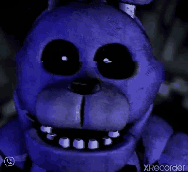 a close up of bonnie the bunny from five nights at freddy 's with glowing eyes .