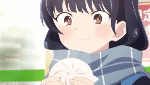 a girl with a scarf around her neck is holding a piece of food in her hands