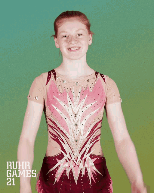 a girl in a red and gold leotard with the words ruhr games 21 on the bottom