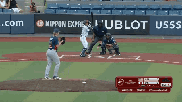a baseball game is being played in front of a banner that says nippon express