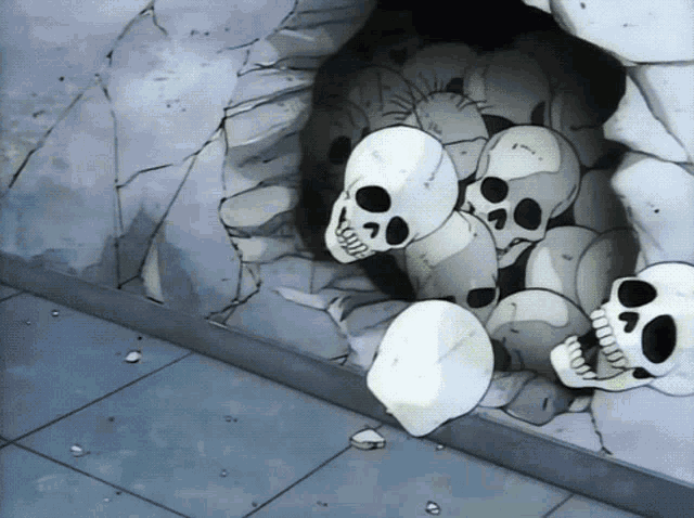 a bunch of skulls are in a cave