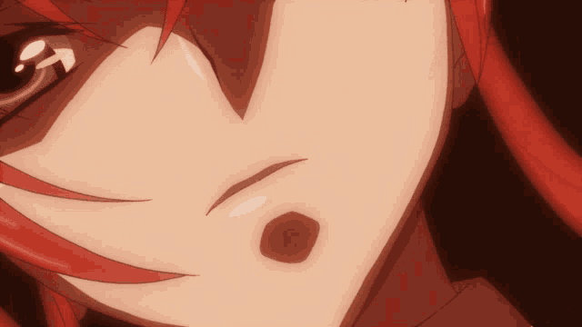 a close up of a person 's face with red hair and a red spot
