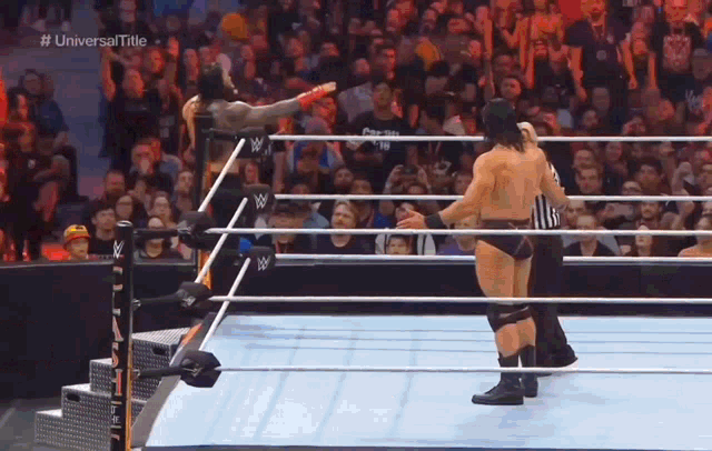 a man in a wrestling ring with the words universal title on the bottom right