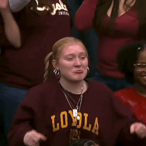 a girl wearing a maroon sweatshirt that says loyal on it