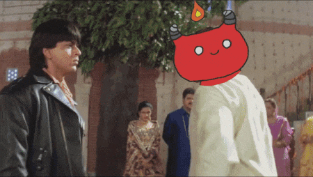 a man in a leather jacket stands in front of a group of people with a red cartoon character on his head
