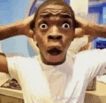 a man is making a funny face with his hands on his head and his mouth open .