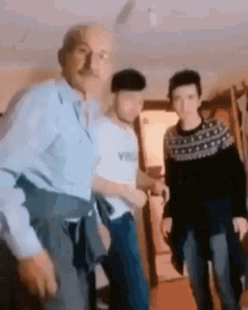 a group of people standing next to each other in a living room .