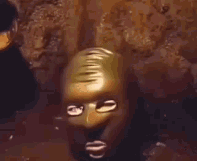 a close up of a statue of a man 's face in a cave .