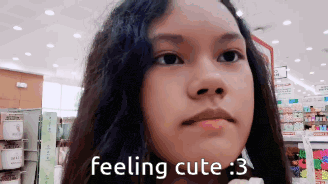 a girl in a store with the words feeling cute 3 on her face