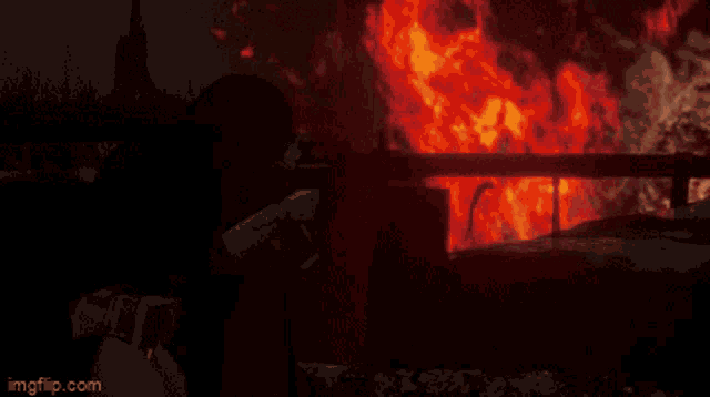 a person holding a gun in front of a fire with imgflip.com at the bottom of the screen
