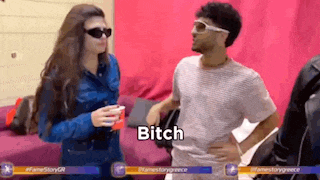 a man and a woman are standing next to each other and the woman is holding a red cup and the man is saying bitch