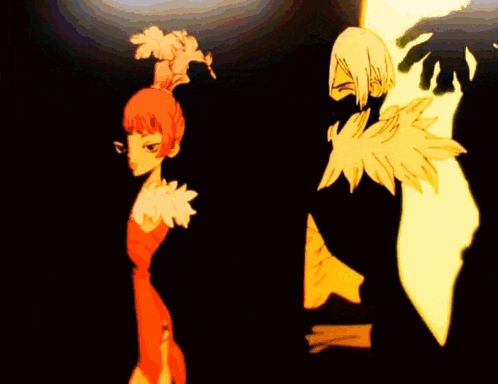 a man and a woman are standing next to each other in a dark room