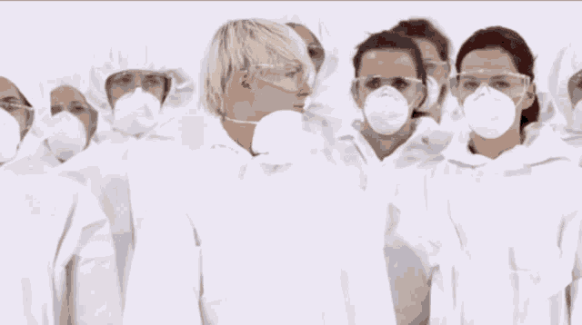 a group of people wearing face masks and goggles stand together