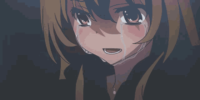 a girl with brown hair is crying with tears running down her face
